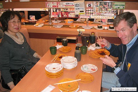 couple with empty sushi plates